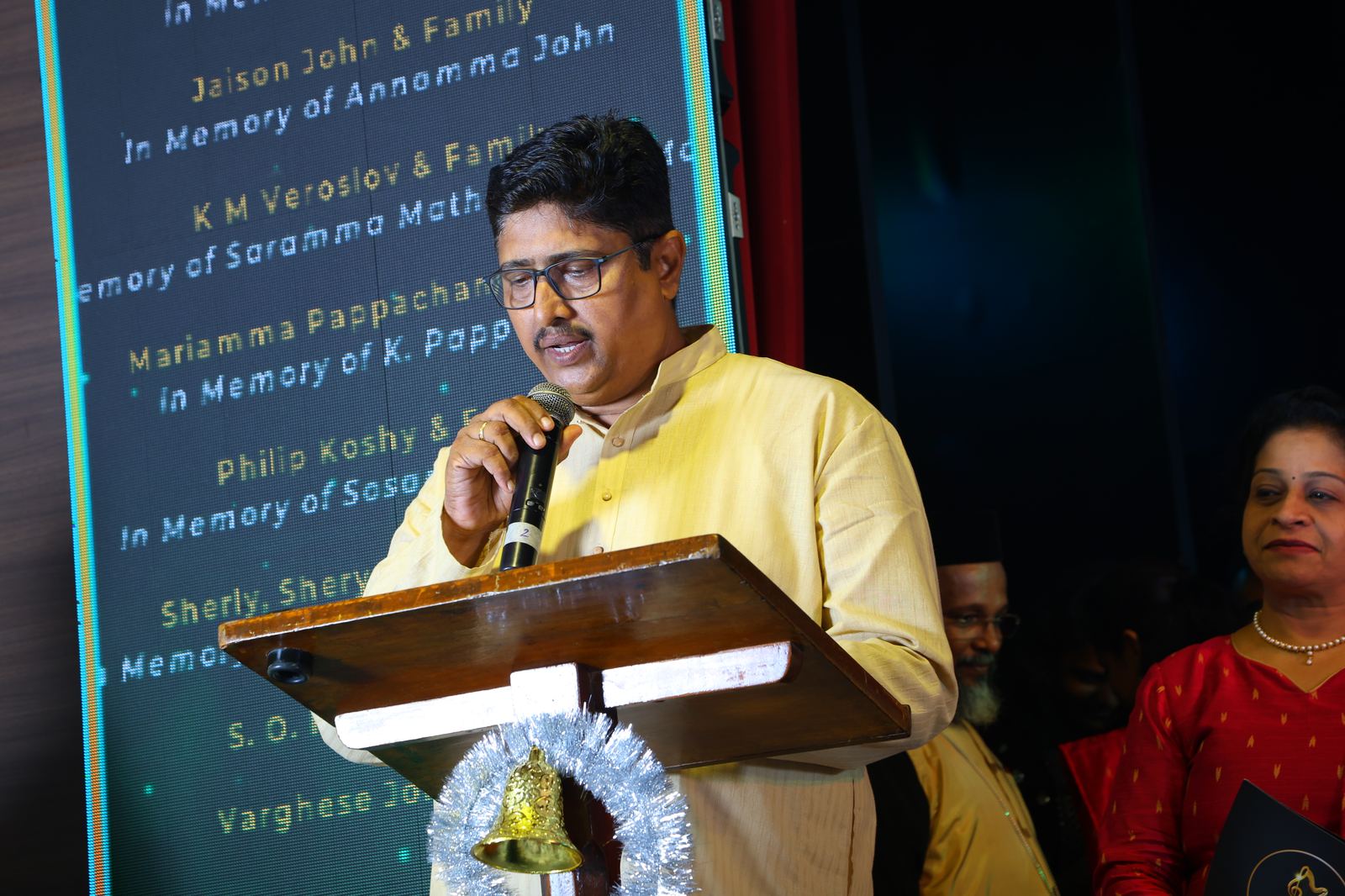 Speaker addressing the audience at the podium